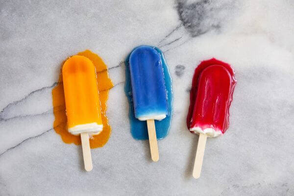 Three popsicles are pictured. They are melting.