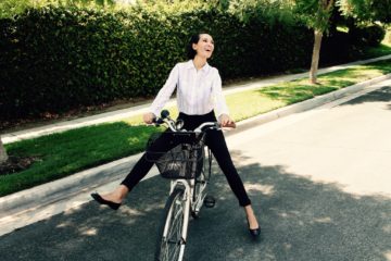 Career woman bike commuting to work.