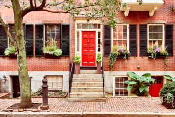A beautiful home with a red door in the Beacon Hill neighborhood of Boston. Gorgeous homes like these have many people wondering if they Should buy a house this year.