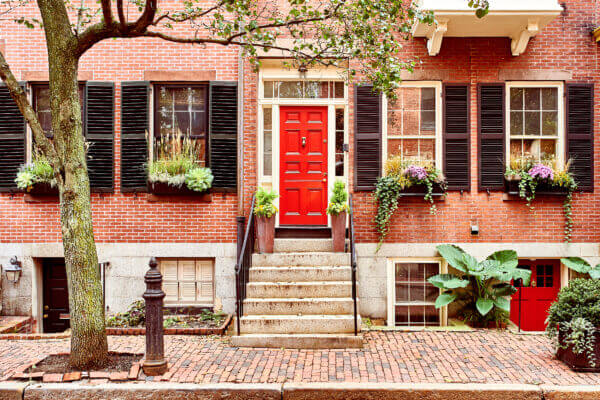 A beautiful home with a red door in the Beacon Hill neighborhood of Boston. Gorgeous homes like these have many people wondering if they Should buy a house this year.