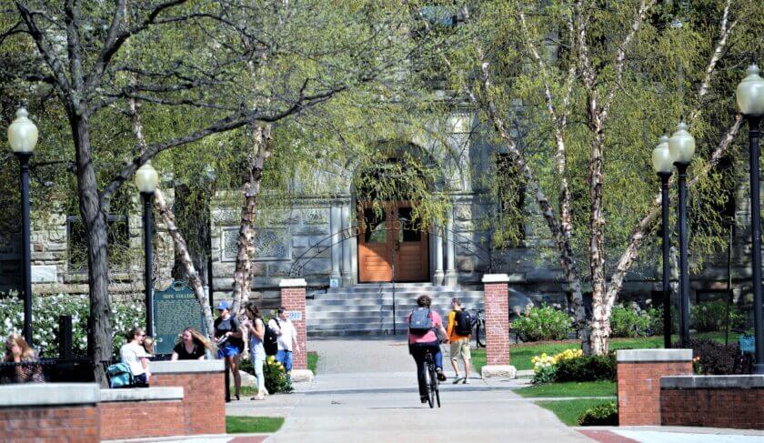 A college campus in the springtime, with students walking to class. What does the SCOTUS decision mean for student loan forgiveness?