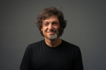 Headshot of Dan Ariely wearing black and smiling at the camera.