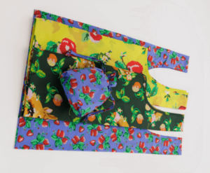 This is an image of several reusable bags in bold, floral patterns that look like needlepoint.