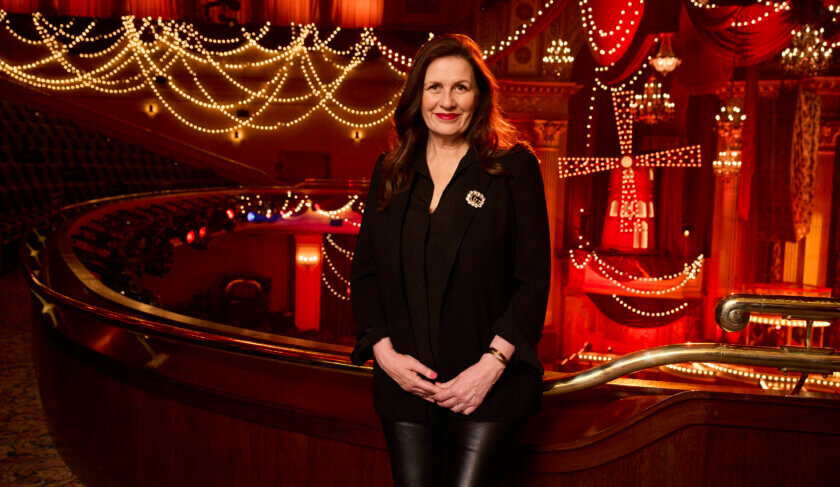 Carmen Pavlovic wearing all black stands on the set of Moulin Rouge! The Musical and smiles.