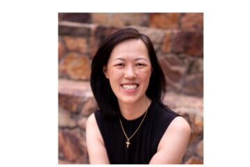 Headshot of Deb Liu wearing black and smiling at the camera.