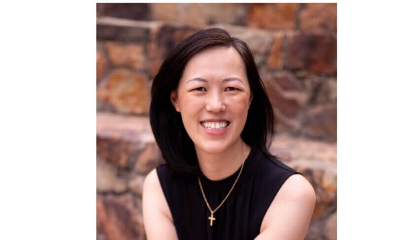 Headshot of Deb Liu wearing black and smiling at the camera.